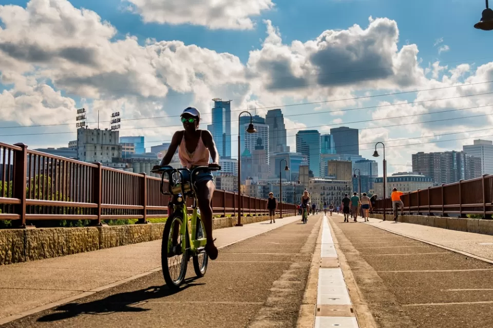 Bike on bridge in Minneapolis with skyline in background